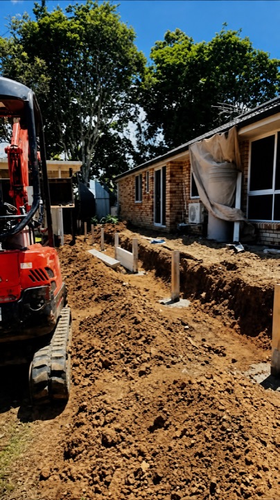 Excavation underway before construction of a residential retaining wall