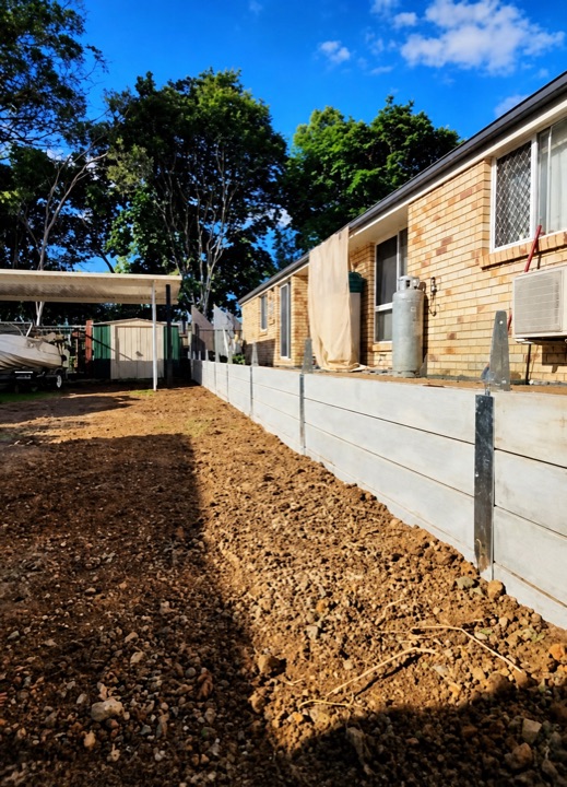 Completed sleeper retaining wall beside a Brisbane home